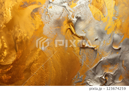 Abstract background of swirling golden and silver paint with metallic sheen 123674259