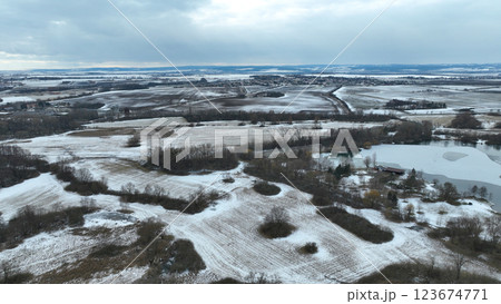 Meadow drone aerial winter landscape snow floodplain frost Plane loucky fog morning over nature snowy reserve, Litovelske Pomoravi icy protected landscape area, pond ice plants, willows, field Europe 123674771
