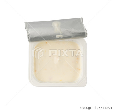 Yogurt cup isolated, yoghurt with orange fruits pieces in plastic pot, milk pudding container Yogurt cup isolated, yoghurt with orange fruits pieces in plastic pot, milk pudding container 123674894