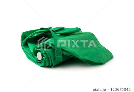 Compact folded umbrella isolated, small green parasol, old umbrella Compact folded umbrella isolated, small green parasol, old umbrella 123675046