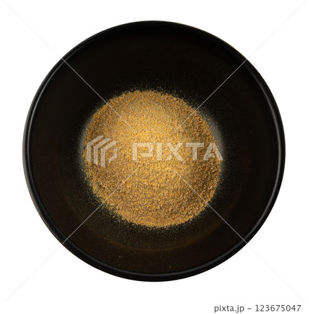 Ground fenugreek seeds in black bowl, milled dry trigonella powder, spicy methi dana pounded 123675047