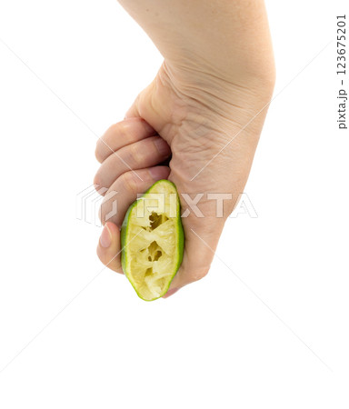 Squeezed lime isolated, squeezed out half green lemon on white background, burnout symbol Squeezed lime isolated, squeezed out half green lemon on white background, burnout symbol 123675201