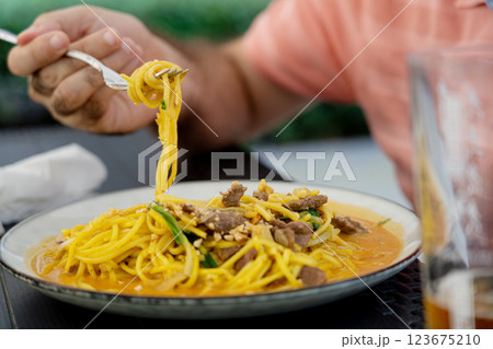 Chiang mai curry noodles, asian spicy egg pasta with meat, curried noodle soup Khao Soi or Khao Sawy, thai food Chiang mai curry noodles, asian spicy egg pasta with meat, curried noodle soup Khao Soi or Khao Sawy, thai food 123675210