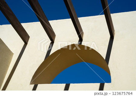 Arabic arched window on yellow wall with crossbars instead of roof 123675764