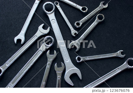 Steel color combination ring and open end wrenches on black velvet surface 123676076