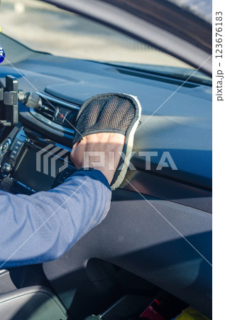 Hand Cleaning Car Dashboard with a Soft Microfiber Mitt for Interior Maintenance. High quality photo 123676183