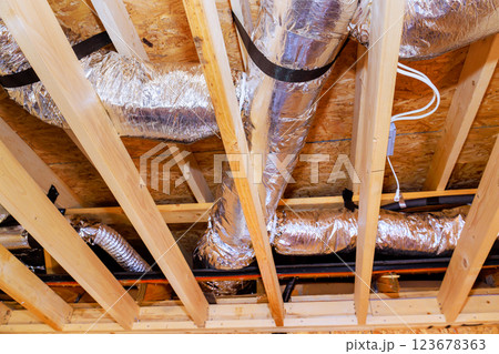 Ducts are being installed in ceiling structure of new building under construction, during ventilation work. Ducts are being installed in ceiling structure of new building under construction, during ventilation work. 123678363