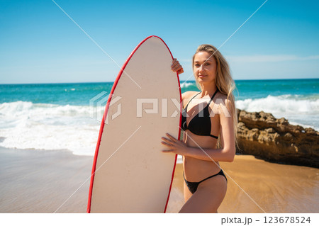 Sensuous surfer woman in bikini standing with Sensuous surfer woman in bikini standing with 123678524