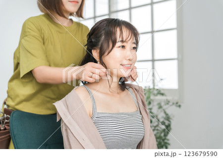 美容室・美容院・ヘアサロンで施術を受ける女性と美容師 美容室・美容院・ヘアサロンで施術を受ける女性と美容師 123679590