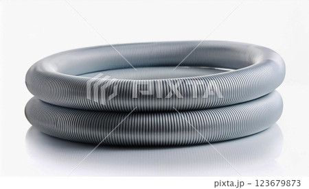 a coiled air conditioning pipe with a ribbed metallic texture, placed on a white reflective surface, industrial design and flexibility of the pipe, making it suitable for HVAC systems, ventilation 123679873