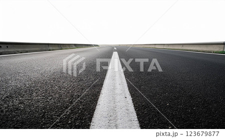 Top down view of a minimalistic asphalt road with dashed lane markings and solid border lines on a white background, the texture of the road and the simplicity of transportation infrastructure 123679877