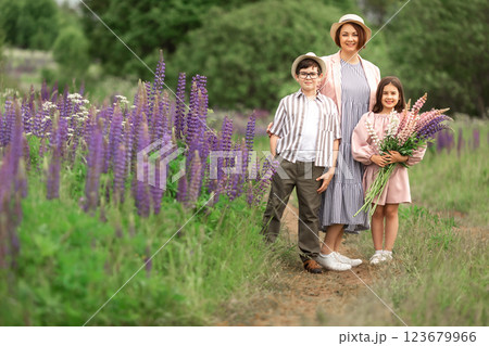 Caucasian family enjoying nature walk in lupine field Caucasian family enjoying nature walk in lupine field 123679966