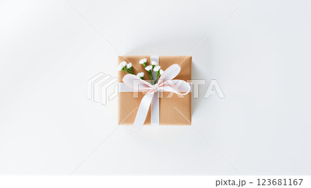 The gift comes in minimalist packaging, decorated with a neutral pink ribbon and flowers symbolizing the arrival of spring. 123681167