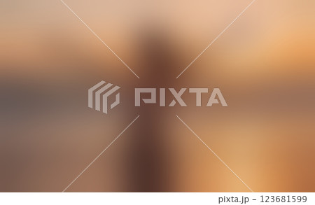 Blurry image of a woman with a blurry background. The woman is wearing a black shirt and she is standing in front of a building. The image has a dreamy, ethereal quality to it 123681599