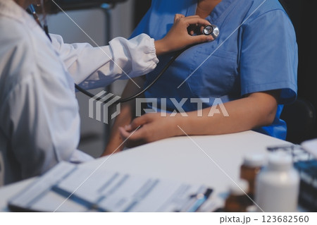 Asian female medical doctor use stethoscope to listen examine check senior  123682560