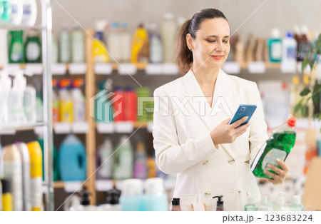 Adult woman scanning qr code for dishwashing 123683224