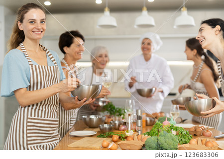 Young woman learns to cook at master class Young woman learns to cook at master class 123683306