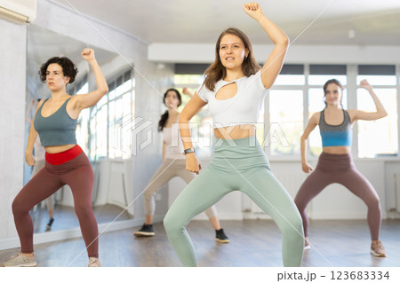 Enthusiastic young girl honing hip-hop moves in dance studio Enthusiastic young girl honing hip-hop moves in dance studio 123683334