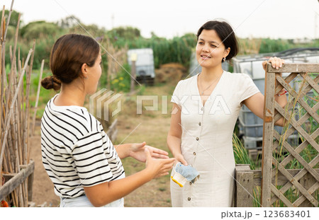 2 females talking at garden 2 females talking at garden 123683401