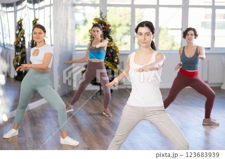 Slender young women dancers dance a swing steps in modern way during the Christmas celebration 123683939