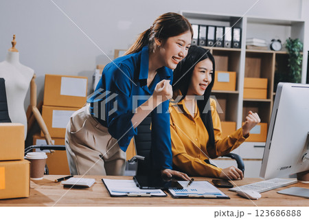 Asian SME business women use laptop computer checking customer order online shipping boxes at home. Starting Small business entrepreneur SME freelance. Online business, Work at home concept. 123686888