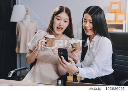Startup SME small business entrepreneur of freelance Asian woman using a laptop with box Cheerful success Asian woman her hand lifts up online marketing packaging box and delivery SME idea concept Startup SME small business entrepreneur of freelance Asian woman using a laptop with box Cheerful success Asian woman her hand lifts up online marketing packaging box and delivery SME idea concept 123686905