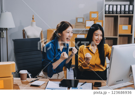 Asian SME business women use laptop computer checking customer order online shipping boxes at home. Starting Small business entrepreneur SME freelance. Online business, Work at home concept. 123686936