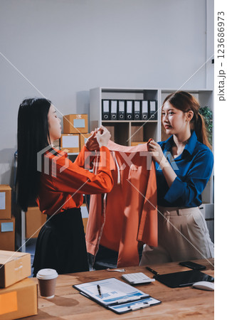 Fashion blogger concept, Young Asian women selling clothes on video streaming.Startup small business SME, using smartphone or tablet taking receive and checking in office Fashion blogger concept, Young Asian women selling clothes on video streaming.Startup small business SME, using smartphone or tablet taking receive and checking in office 123686973