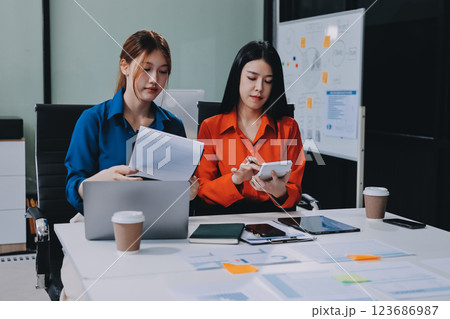 Entrepreneur Asian businessman and businesswoman discussing new business project in tablet in modern Meeting In Modern Office, Asian business casual concept. Entrepreneur Asian businessman and businesswoman discussing new business project in tablet in modern Meeting In Modern Office, Asian business casual concept. 123686987