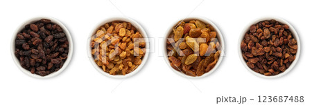 Bowl plates with sweet healthy raisins made from green and red grapes isolated on white background. 123687488