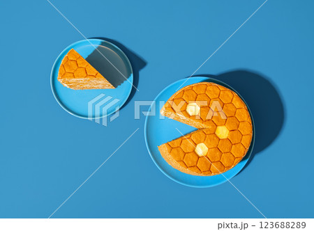 Homemade honey layered cake, in bright light minimalist on a blue table 123688289