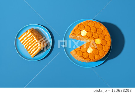 Medovik, russian honey cake, in bright light minimalist on a blue table Medovik, russian honey cake, in bright light minimalist on a blue table 123688298