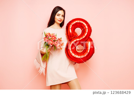 Woman hold bouquet of flowers and balloon number 8 123688429