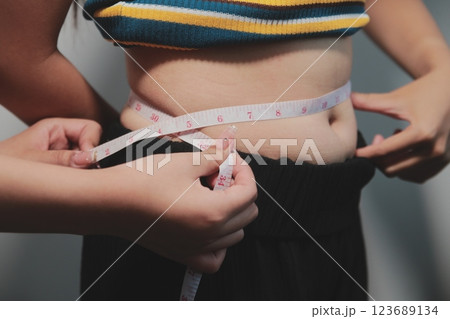 Women body fat belly. Obese woman hand holding excessive belly fat. diet lifestyle concept to reduce belly and shape up healthy stomach muscle. Women body fat belly. Obese woman hand holding excessive belly fat. diet lifestyle concept to reduce belly and shape up healthy stomach muscle. 123689134