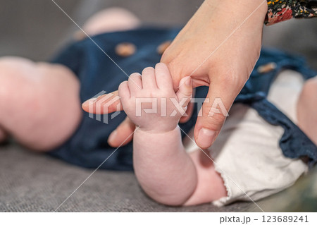 sweet tiny new born baby hand hold mum index finger. concept relationship between mother or parants and baby sweet tiny new born baby hand hold mum index finger. concept relationship between mother or parants and baby 123689241