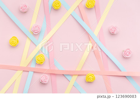 Paper strips with rosebuds on pink background Paper strips with rosebuds on pink background 123690083