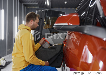Side view on man master working at car wash service Side view on man master working at car wash service 123692888