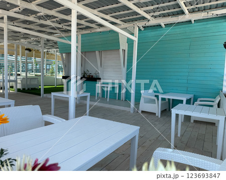 Interior of a summer wooden restaurant with tables without people 123693847