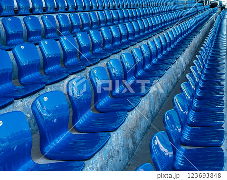 Lots of seats in the stadium grandstand with no people Lots of seats in the stadium grandstand with no people 123693848