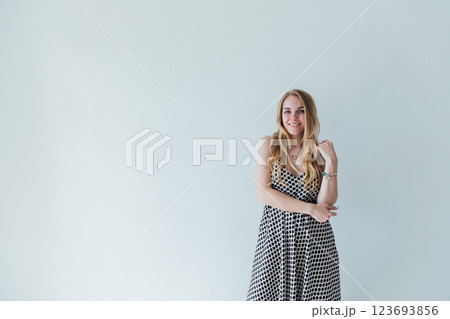 Beautiful fashion blonde woman smiling in summer light dress Beautiful fashion blonde woman smiling in summer light dress 123693856