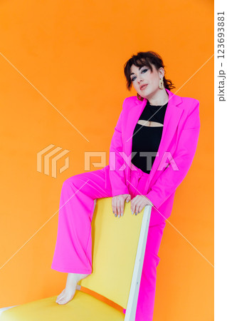 Beautiful fashionable brunette woman in crimson suit Beautiful fashionable brunette woman in crimson suit 123693881