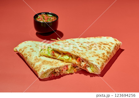 Quesadilla with chicken, cheese, vegetables and herbs and sauce 123694256