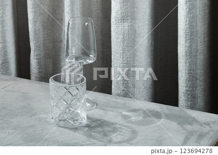Empty glasses for drinks and cocktails on a gray table Empty glasses for drinks and cocktails on a gray table 123694278