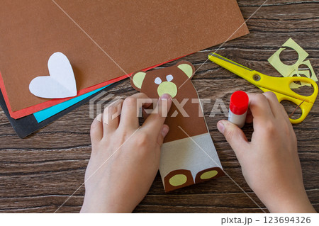 Instruction, step 8. On Mothers Day or Valentines Day gift - a teddy bear with a heart-card. Handmade paper ideas. Childrens creativity project, handmade, crafts for kids. 123694326