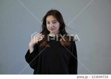 Young woman with tousled hair, giving a sense of motion. Depicts the dance of life and vitality of the human spirit. 123694728