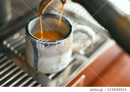 Close up of coffee machine pouring espresso in cafe Close up of coffee machine pouring espresso in cafe 123694924