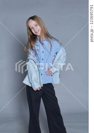 A poised pre-teen shows off a relaxed yet stylish look. Great for back-to-school campaigns and youth clothing lines. A poised pre-teen shows off a relaxed yet stylish look. Great for back-to-school campaigns and youth clothing lines. 123695791
