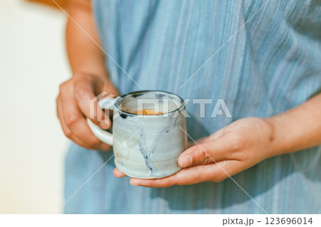 hand holding a cup of espresso shot. 123696014