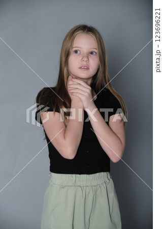 Young dreamer holds a reflective pose, lost in thought. Showcases the profound inner world of a growing mind. Young dreamer holds a reflective pose, lost in thought. Showcases the profound inner world of a growing mind. 123696221