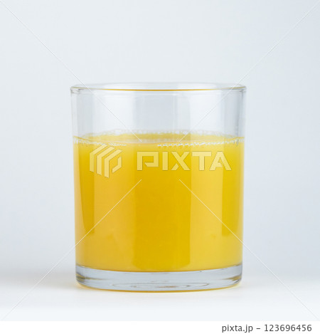 Freshly squeezed orange juice in a clear glass. High quality photo 123696456